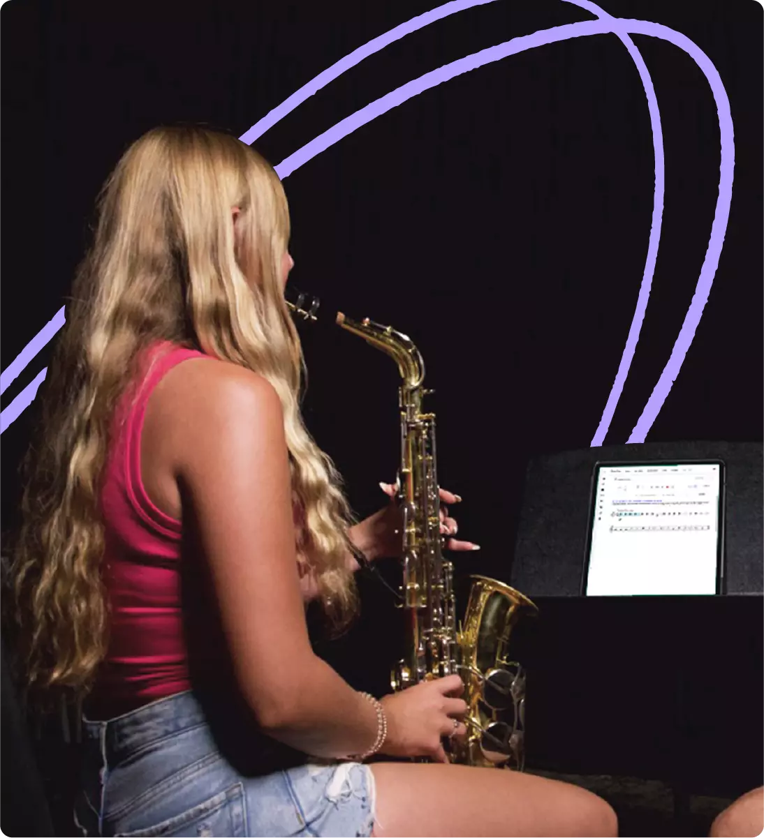 Student practicing alto saxophone from MakeMusic Cloud app in classroom setting